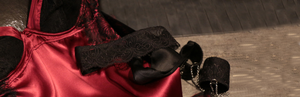 Alicia Slip merges luxurious silk with feather-adorned lace. Its sheer panels give a glimpse of skin, while the silky fabric clings to your silhouette. Paired with our pleasure mask and cuffs.